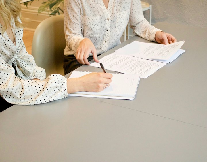 Two people reviewing incorporation documents at a table